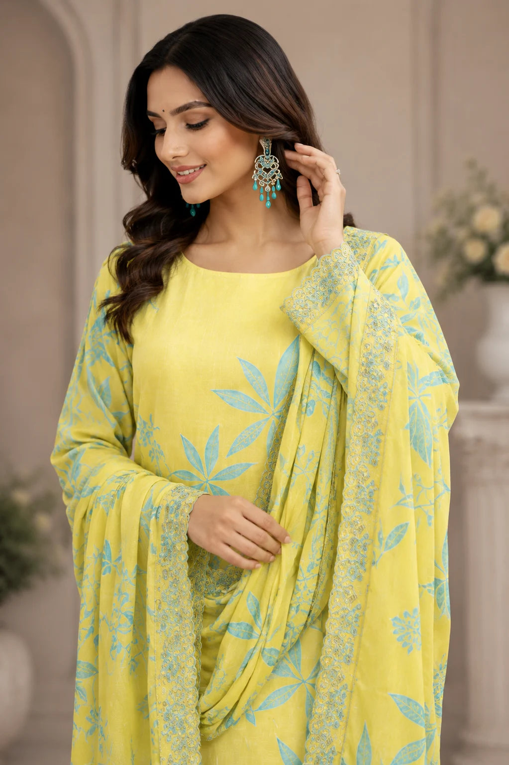 Woman wearing a yellow outfit with floral patterns indoors